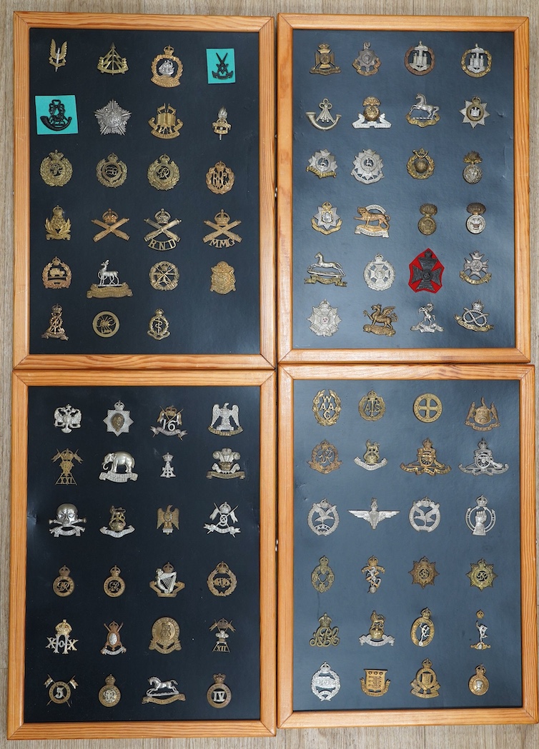 A collection of ninety-five military cap badges mounted on four boards including; The Reconnaissance Corps, RAEC, Royal Engineers, Small Arms School, Royal Warwickshire 1st Birmingham Battalion, Royal Army Medical Corps,